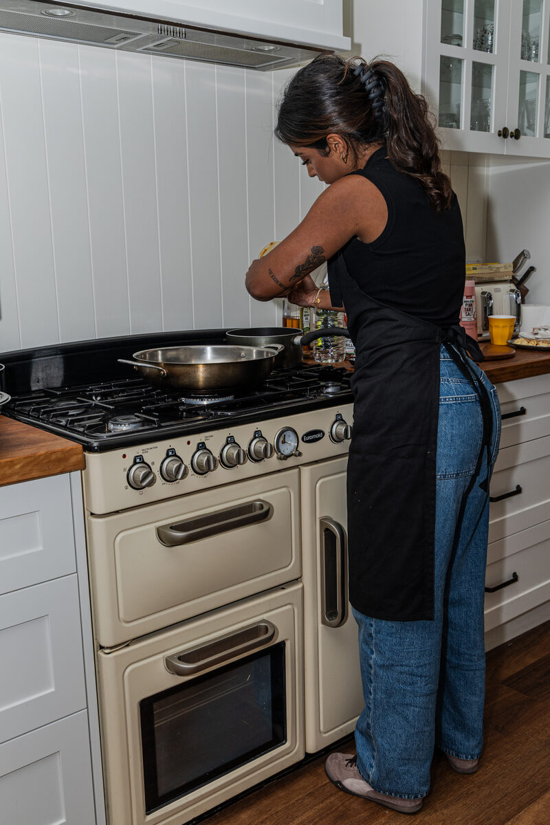 Shivaani cooking at the stove
